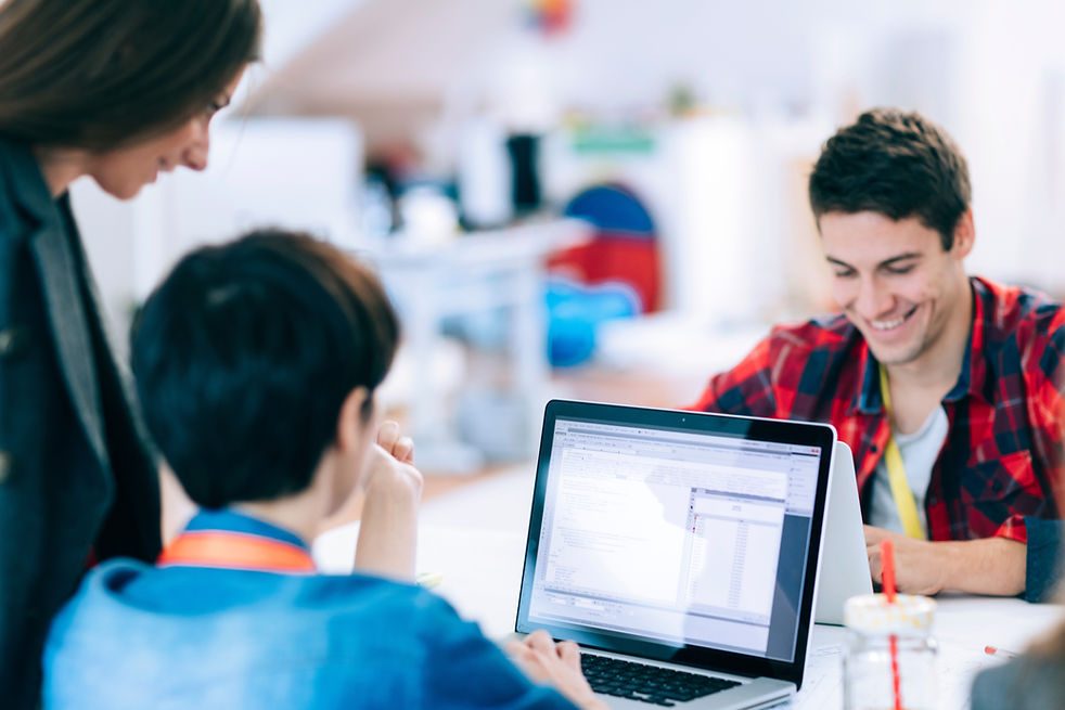 A small team working together at a laptop